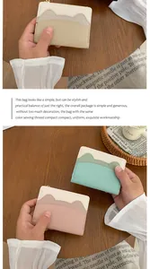 Detail of slim women wallet with cat-ear shaped pocket and multi-color PU leather design