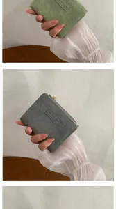 Detail of square PU leather wallet with pleated texture and gold metal zipper closure