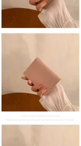 Close-up of lychee textured PU leather wallet showing clean stitching and compact folding design