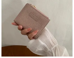 Macro view of pink wrinkled PU leather card holder with zip closure and Mo Mo Dog logo