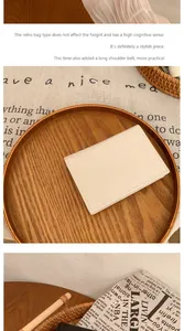 Close-up of ivory pebble grain texture and precise stitching on minimalist slim wallet