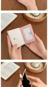 Detail view of bi-fold card holder featuring inner pink lining and transparent ID window