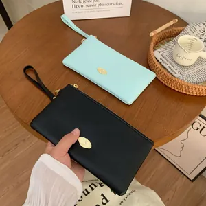 Elegant long leather clutch wallet with wristlet strap in black and mint green