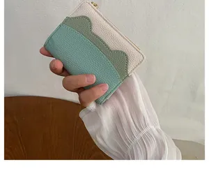 Close-up of tricolor litchi texture card holder with wave slots and gold zipper