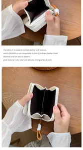 Detail of white cowhide leather wallet showing interior compartments and textured finish