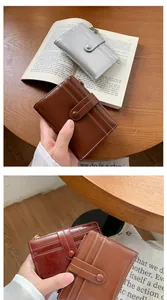 Dettaglio di portafoglio compatto in pelle con zip dorata e fessure per carte in stile di vita