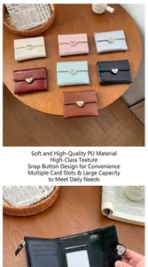 Close-up of internal slots and heart snap button on a compact foldable PU leather wallet