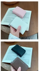 Detail view of multi-color crocodile texture zipper card holders in a lifestyle setting