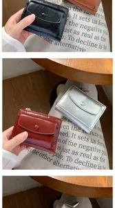 Macro shot of compact faux leather wallets with retro crinkle texture and snap closure