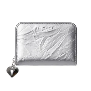 Detail of silver metallic wrinkled texture card holder with a silver heart zipper pull