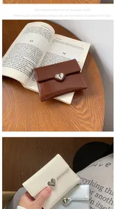 Detailed close-up of compact tri-fold heart wallets in dark brown and beige PU leather