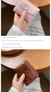 Detail of vintage PU leather women's wallets with round clasp and zipper in pastel pink and brown