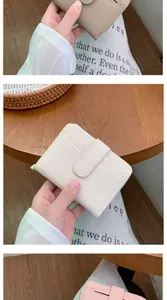Detail showing various colors of lychee grain leather short wallets with snap button closure