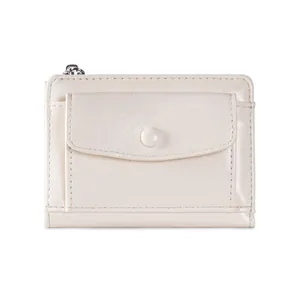 Detailed macro view of the cream white faux leather short wallet with a button flap pocket