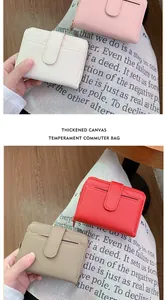 Close-up of small bi-fold PU leather wallets in pink, red, and beige with card slots