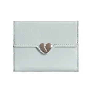 Close-up of mint blue heart-shaped silver buckle on textured leather wallet