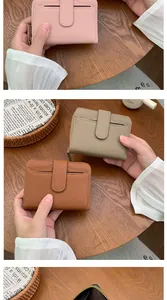 Detailed close-up of pebbled leather wallets in pink and brown with card slots