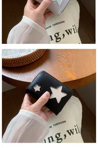 Close-up of minimalist small wallet with star pattern in black and light blue PU leather