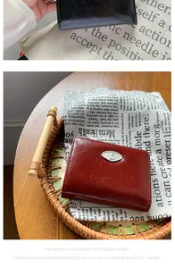 Detail of vintage oil wax leather wallet with retro metallic S buckle and fine stitching