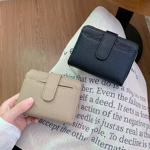 Short minimalist zip-around wallet for women in black and beige with lychee grain texture