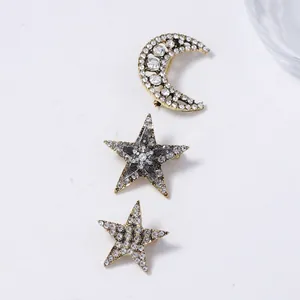 Golden crescent moon and sparkling star brooch set with rhinestones and elegant vintage design