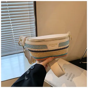 Detail of colorful woven texture and golden hardware on a white leather chest bag