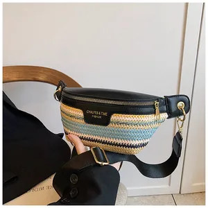 Detail of multi-color woven crossbody bag with black leather trim and gold zippers