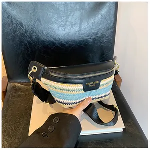 Detail of woven patchwork crossbody bag with colorful stripes and gold zipper hardware