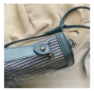 Macro shot of blue-white woven texture and premium silver hardware on small crossbody bag