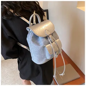 Rear view of stylish PU leather and denim patchwork backpack worn by a model