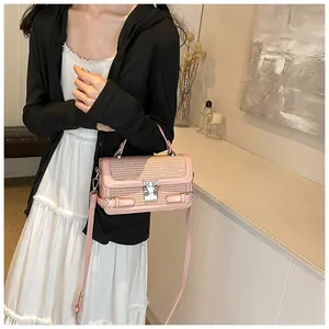 Pink woven leather handbag detail with silver butterfly clasp and adjustable strap