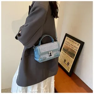 Detail of the metal butterfly clasp on a blue plaid fashion handbag for women