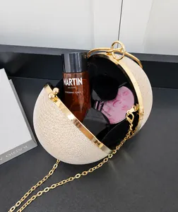 Interior of champagne gold spherical evening bag showing space for cosmetics and sunglasses