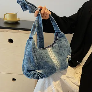 Relaxed vintage washed denim hobo bag with knotted strap and pearl detail accents