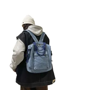 Retro light blue washed denim backpack with adjustable straps and front zipper pocket