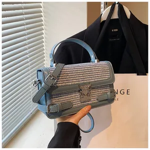 Macro detail of Morandi blue leather and woven fabric small square crossbody handbag