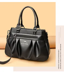 Detail of black crossbody bag showing pebbled leather texture and front zipper pocket