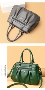 Detail showing the pleated faux leather texture and metal kangaroo logo on the handbag