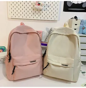 Detailopname van minimalistische nylon rugzakken in roze en beige met ritszakken