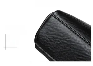 Close-up of black litchi grain leather texture with precision stitching on shell bag
