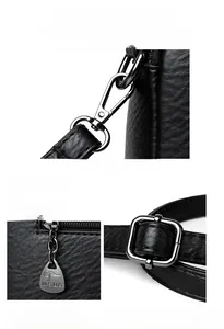 Detail of lychee textured leather and metallic buckle with a logo zipper pull