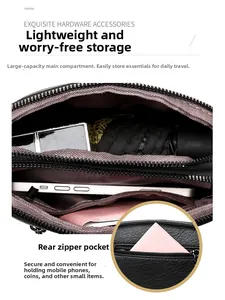 Detail view of black leather shell bag showing spacious main pocket and back zipper slot