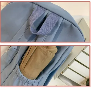 Detail van de versterkte rugzakhandgreep en zijzak met een compacte paraplu erin