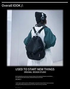 Detailed macro view of black washed canvas backpack showing high-density fabric and metal zippers