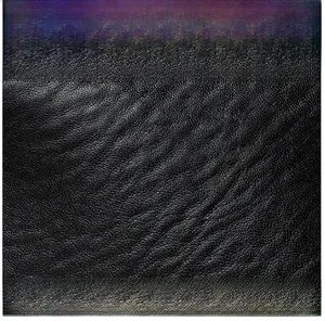 Macro shot of high-quality black lychee texture leather with matte finish detail