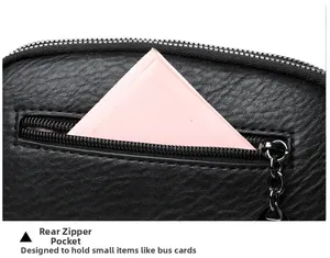 Detailed macro view of the rear zipper pocket on a black litchi grain leather crossbody bag