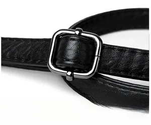 Detail of adjustable black leather shoulder strap with dark metallic buckle for handbags