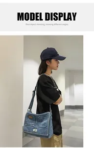 Detail of denim crossbody bag with C-letter patch and metal twist lock on a casual model