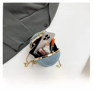 Blue sphere evening bag interior view with chain strap and gold clasp detail