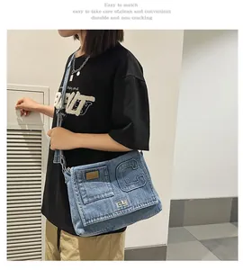 Close-up of a blue denim crossbody bag with C-patch and metal clasp on a model